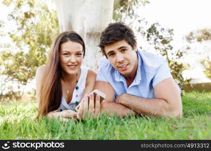 Young couple in the park. Young couple in the park with mobile phone