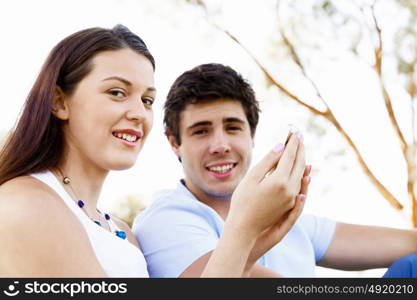 Young couple in the park. Young couple in the park with mobile phone