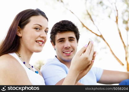 Young couple in the park. Young couple in the park with mobile phone