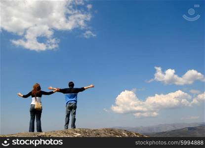 young couple in the top of the mountain