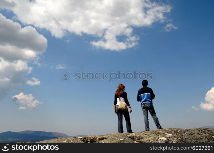 young couple in the top of the mountains