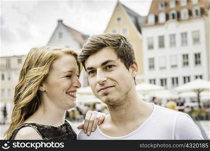 Young couple in town square in Augsburg, Bavaria, Germany