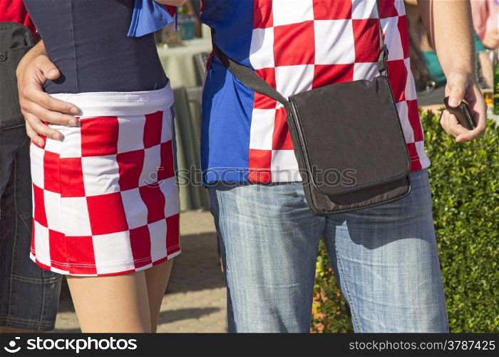 Young couple in traditional uniform of Croatian football fans