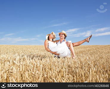 young couple in wheat field