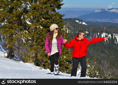 Young Couple In winter Snow Scene at beautiful sunny day