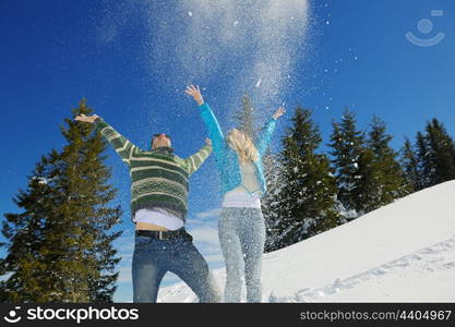 Young Couple In winter Snow Scene at beautiful sunny day