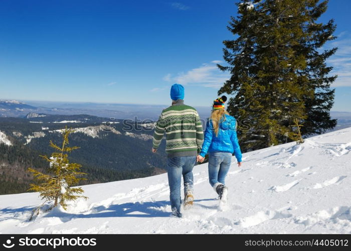 Young Couple In winter Snow Scene at beautiful sunny day