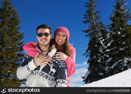 Young Couple In winter Snow Scene at beautiful sunny day