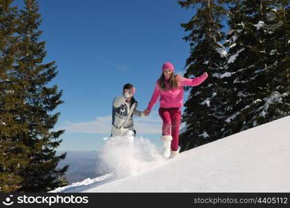 Young Couple In winter Snow Scene at beautiful sunny day