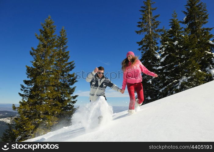 Young Couple In winter Snow Scene at beautiful sunny day