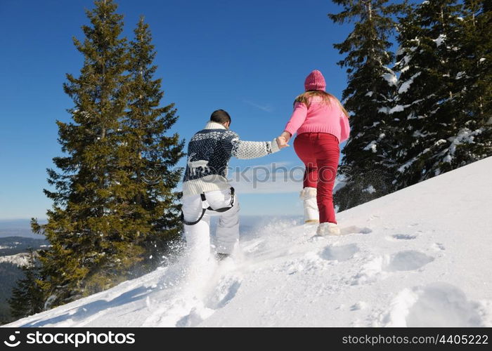 Young Couple In winter Snow Scene at beautiful sunny day