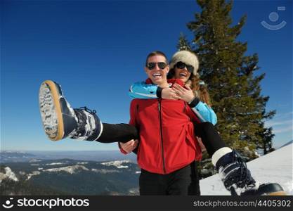Young Couple In winter Snow Scene at beautiful sunny day
