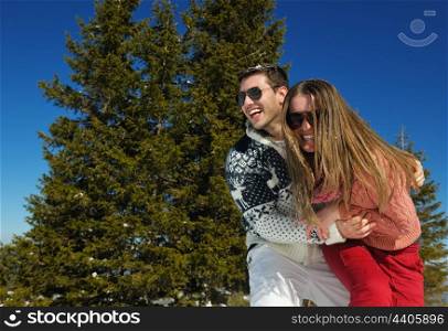 Young Couple In winter Snow Scene at beautiful sunny day