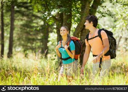 Young couple is doing tracking in the woods