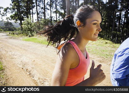 Young couple jogging in forest