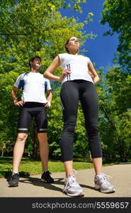 Young couple jogging in park at morning. Health and fitness.