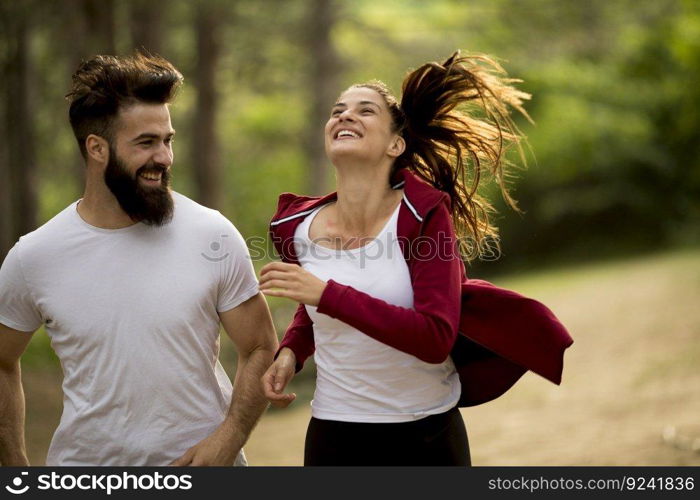 Young couple jogging outdoors in nature