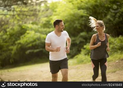 Young couple jogging outdoors in nature
