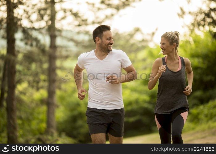 Young couple jogging outdoors in nature