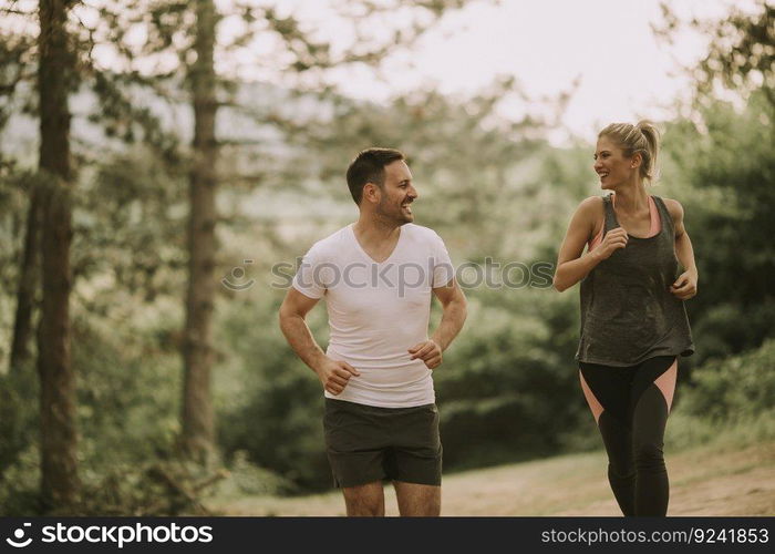 Young couple jogging outdoors in nature