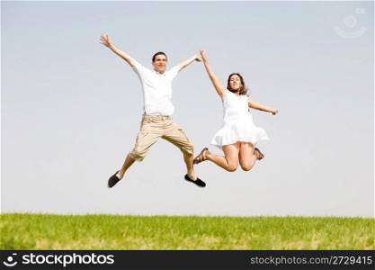 Young Couple Jumping On The park