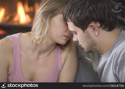 Young couple kiss by open fire