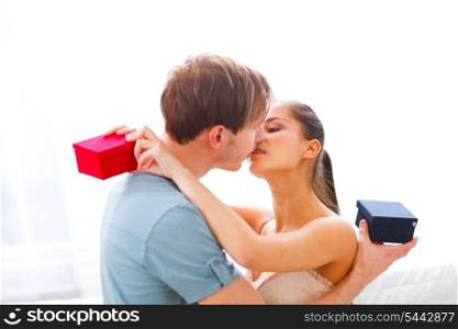 Young couple kissing after exchanging presents&#xA;
