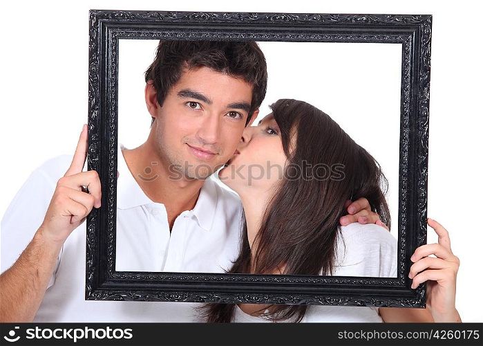 Young couple kissing in a frame