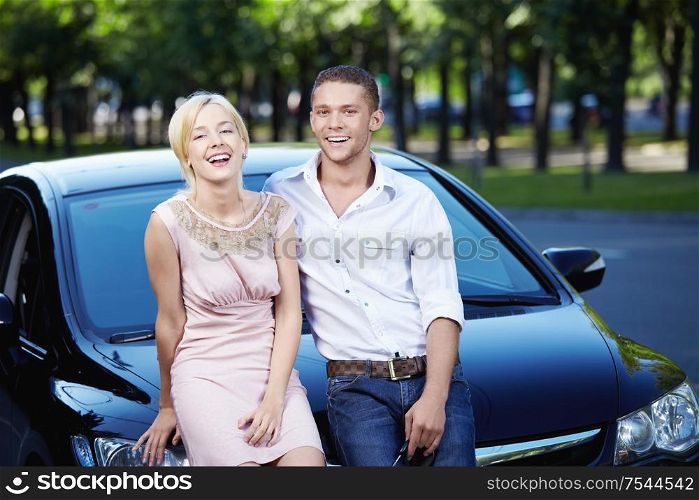 Young couple laughing in car