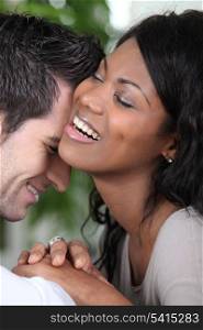 Young couple laughing intimately