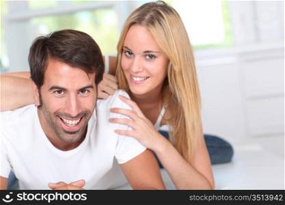 Young couple laying down sofa
