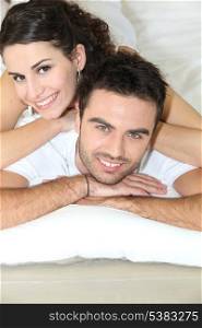 Young couple laying in bed