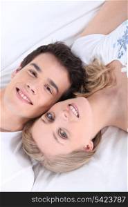 Young couple laying next to each other