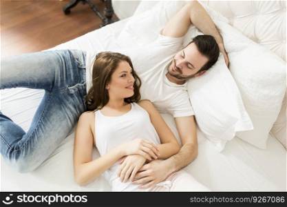 Young couple laying together in the bed