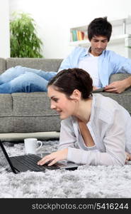 Young couple lazing about at home