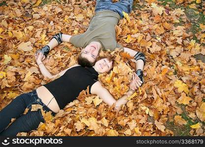 young couple lies on yellow leaves 2