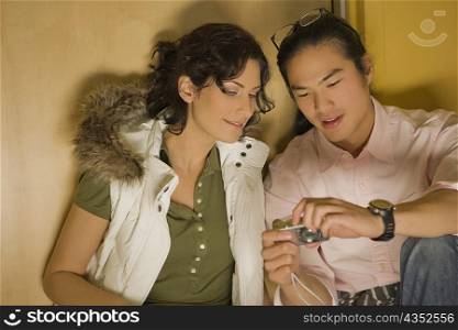 Young couple looking at a digital camera