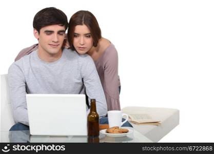 Young couple looking at a laptop