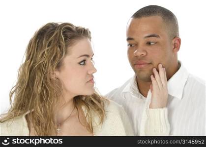 Young couple looking at each other. Headshot over white.