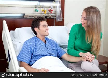 Young couple looking at each other in hospital