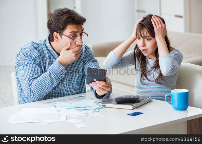 Young couple looking at family finance papers