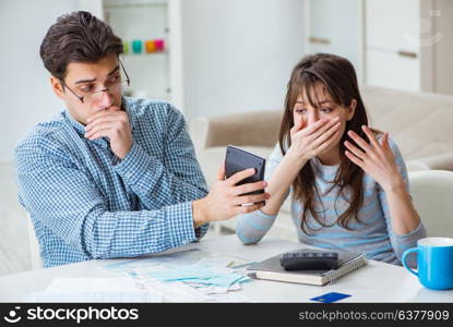 Young couple looking at family finance papers