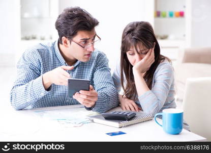 Young couple looking at family finance papers