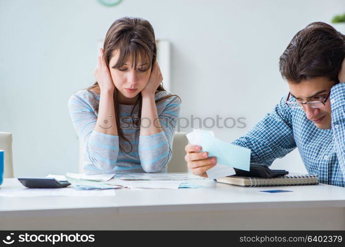 Young couple looking at family finance papers