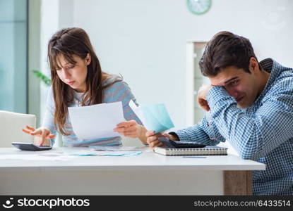 Young couple looking at family finance papers