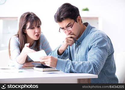 Young couple looking at family finance papers