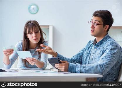Young couple looking at family finance papers