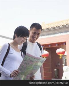 Young couple looking at map.
