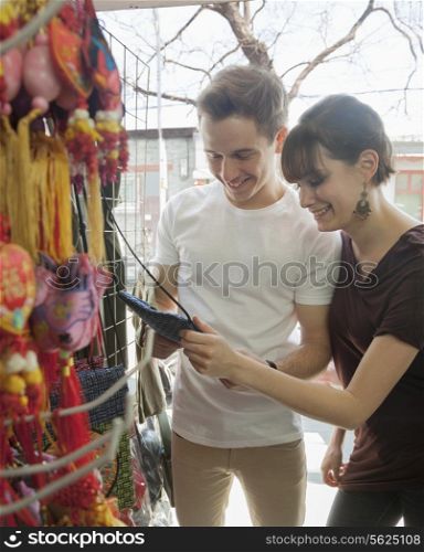 Young couple looking at souvenirs.