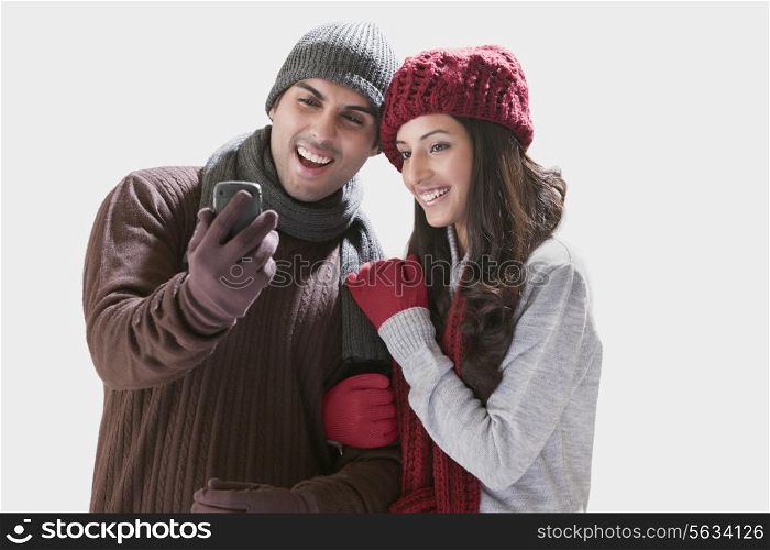 Young couple looking at their photos in mobile phone